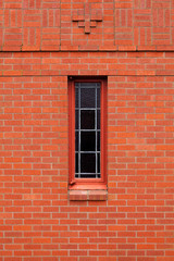 Fototapeta na wymiar Single narrow window in brick wall
