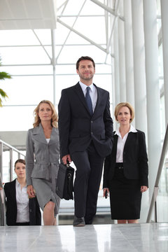 group of executives walking up stairs
