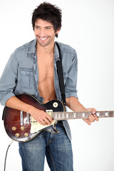 young man playing on his electric guitar