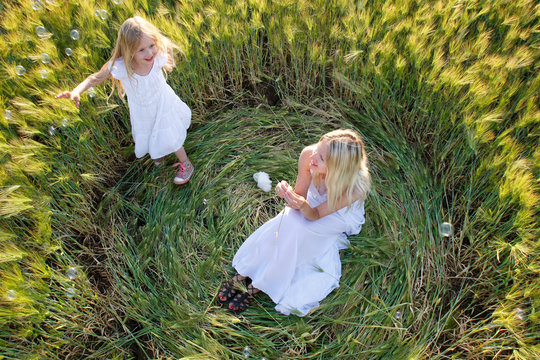 mother and daughter in green field