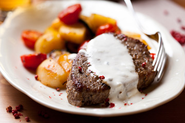 Steak with baked vegetables and sauce