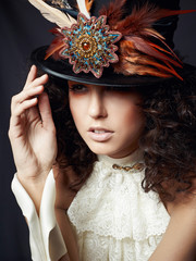Portrait of a woman in a hat with feathers