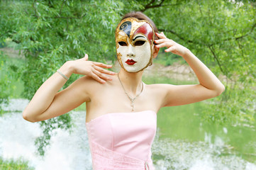 Young woman with mask in the park