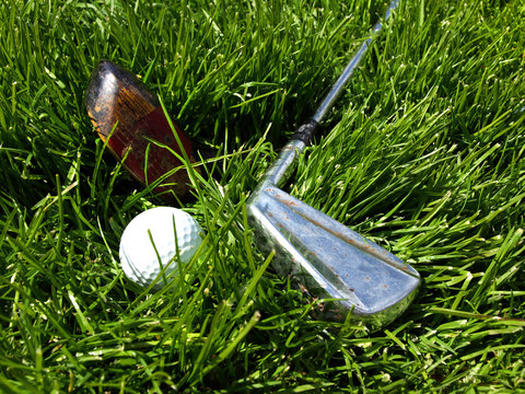 Golf clubs and ball still life image
