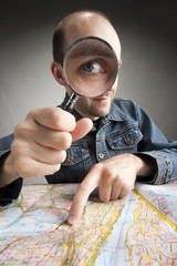 Funny tourist discovering map