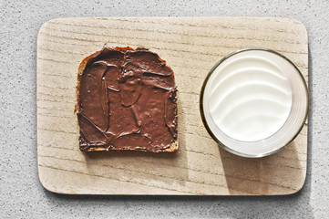 Breakfast with a toast of chocolate cream and a glass milk