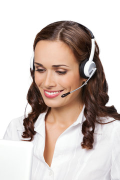 Young support phone operator in headset with laptop, isolated