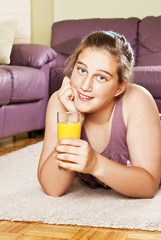 Teenage girl with orange drink