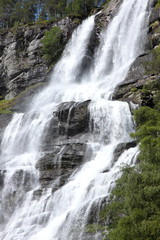 Fototapeta premium Big waterfall in a fjord it norway in spring