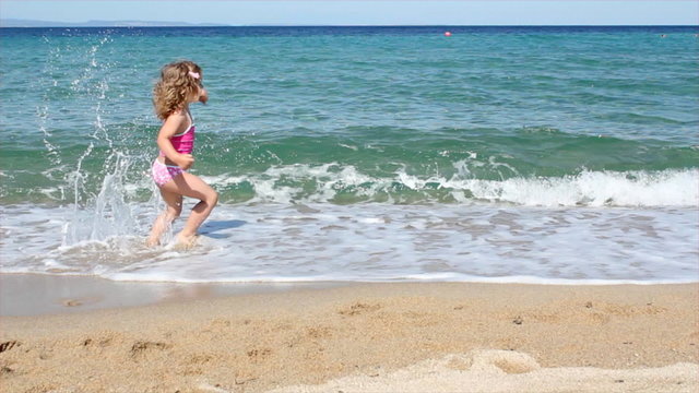little girl running in water