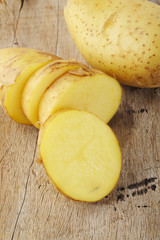 yellow potato on wood background