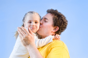 Fototapeta premium man kisses his daughter