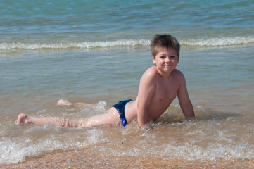 A boy swims in the sea