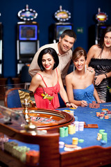 group of elegant people playing roulette