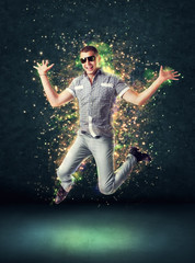 Fototapeta na wymiar Jumping smiling young man on glowing abstract background