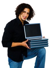 Smiling man holding laptops