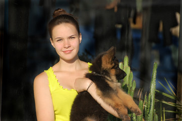 Teenager girl and German Shepherd dog puppy