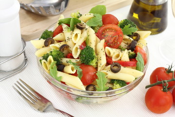 Penne pasta salad with vegetables and herbs