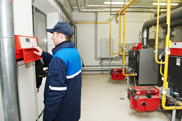 heating engineer repairman in boiler room