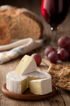Traditional Normandy Camembert cheese with homemade bread, glass