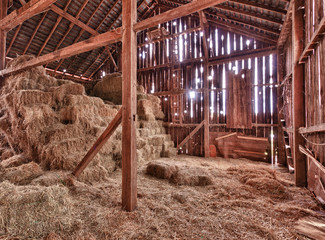 Interior of old barn with straw bales - obrazy, fototapety, plakaty