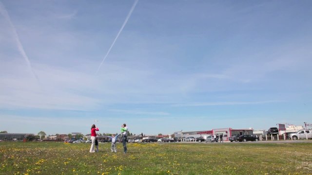 Family running under airplane landing