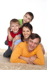 Fototapeta na wymiar happy family on a carpet
