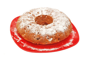 Round biscuit cake on plate, isolated on a white background