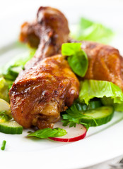 Roasted chicken legs with salad and fresh herbs