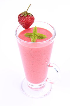 Strawberry shake in a glass with a strawberry and mint