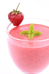 Strawberry shake in a glass with a strawberry and mint