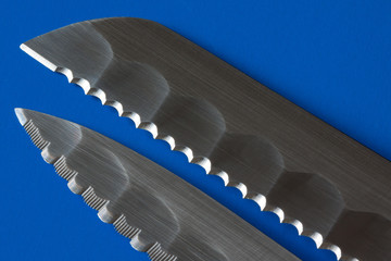 Two knife blades in blue background