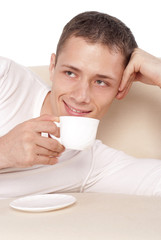 guy with cup on sofa