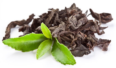 Heap of dry tea with green tea leaves.