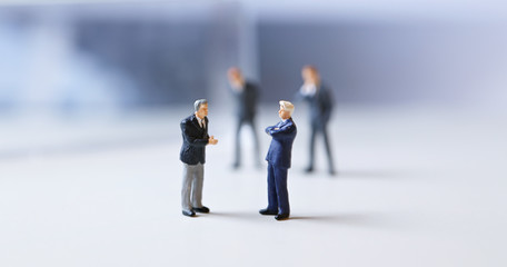Miniature figurines of successful business team.