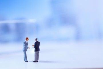 Miniature figurines of successful business team.