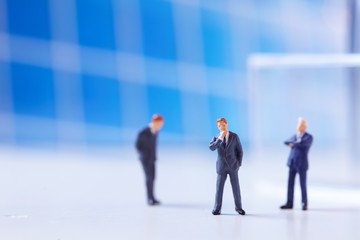 Miniature figurines of successful business team.