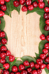 cherries frame on wooden background