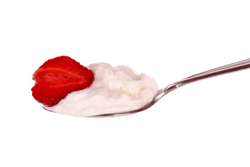 strawberry in spoon with cream isolated on white