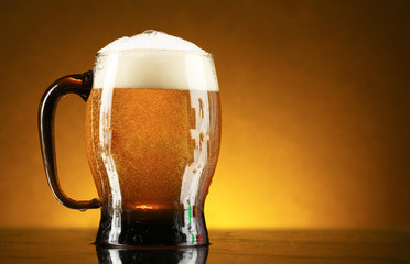 mug of beer on a yellow background
