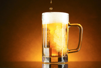mug of beer on a yellow background