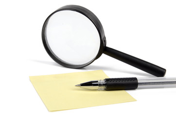 Magnifier,pen and notepaper