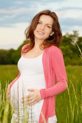 Beautiful pregnant woman in the park