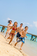 Family running on the beach