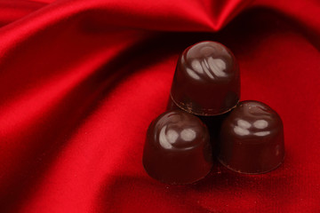 chocolate candy on red satin