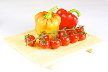 fresh and juicy vegetables on the wood plate isolated