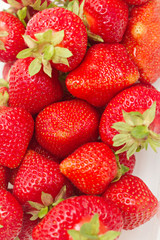 lots of fresh strawberries against white background