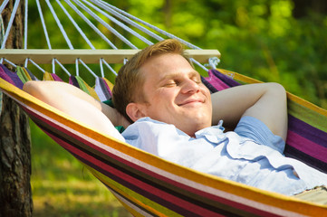 Young man sleeping in a hammock