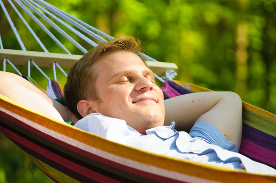 Young Man Sleeping In A Hammock