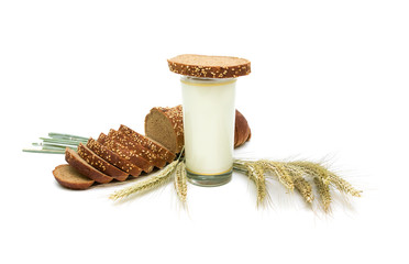 Still Life. bread, a glass of milk and wheat ears on a white bac